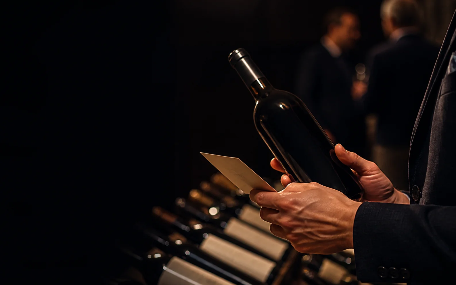 A wine auction preview with an unbranded bottle and lot card